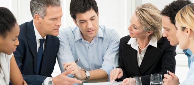 Portrait Of Multiracial Businesspeople Brainstorming In Meeting